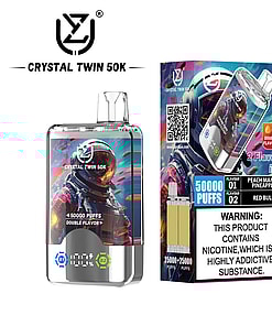 Crystal Twin 50K disposable vape packaging and device featuring a colorful astronaut design, branding, flavor descriptions (peach mango pineapple and red bull), 50,000 puffs double flavor label, and a nicotine addiction warning.