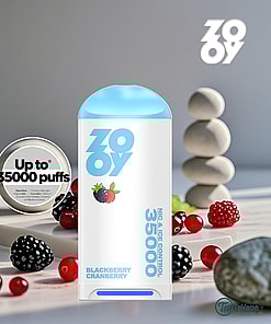 ZOOVY Blackberry Cranberry vape device with blue lid, surrounded by blackberries, cranberries, and decorative stones, promoting up to 35,000 puffs.