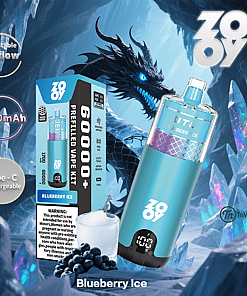 Promotional image for a ZOOVY Blueberry Ice prefilled vape kit featuring the device, a box displaying specifications like 6000+ puffs and 1700mAh battery, blueberries with ice, and an illustrated black dragon in an icy cave background.